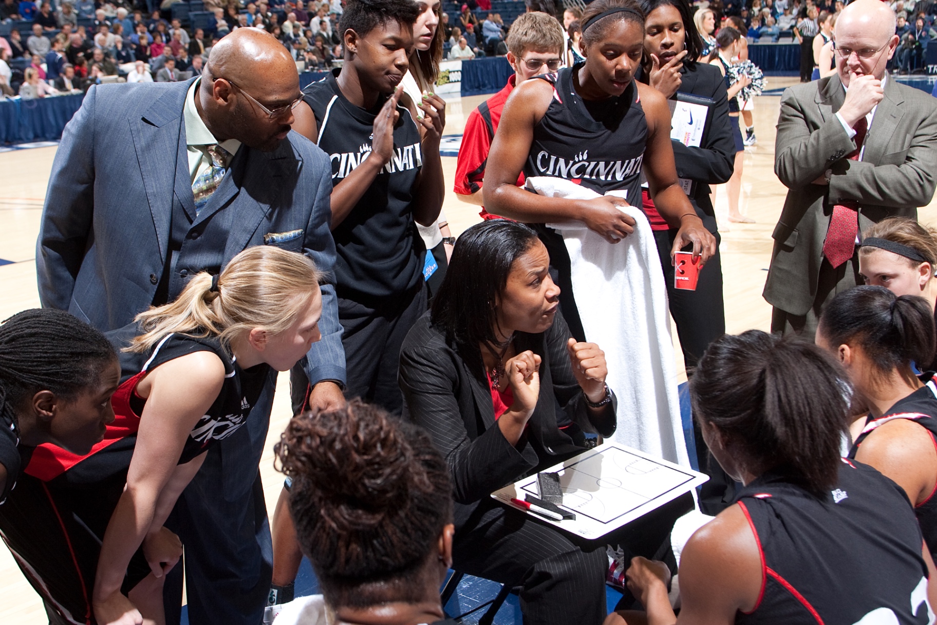 Coaching huddle during a Cincinnati Bearcats game