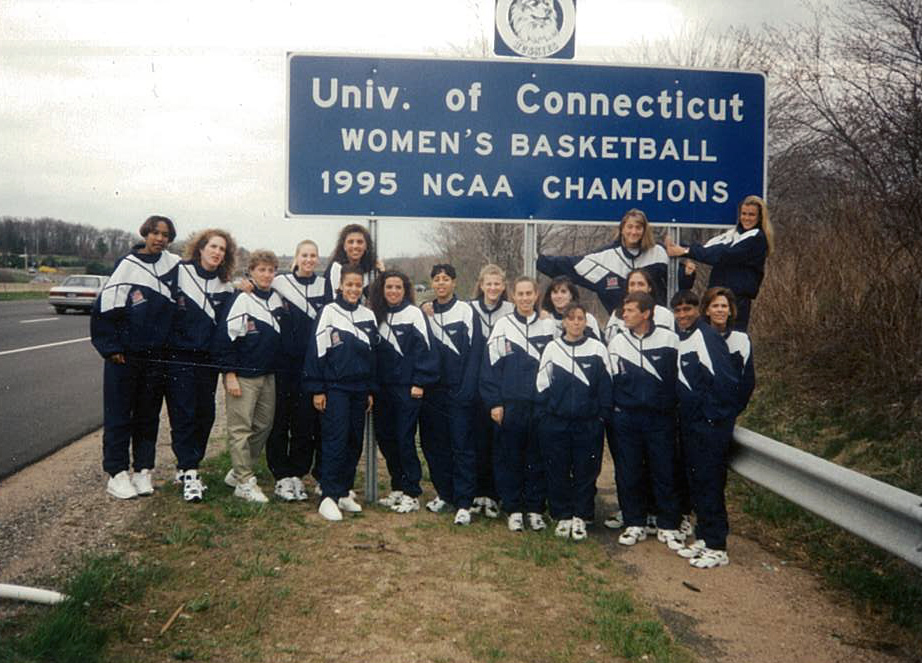 The 1995 UConn Women's Basketball NCAA champions team beneath the highway sign